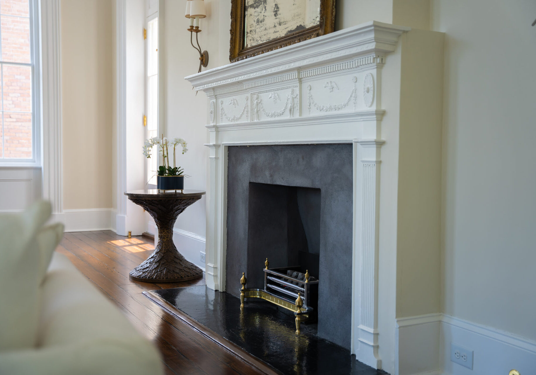 A fireplace with a white mantle and black hearth.